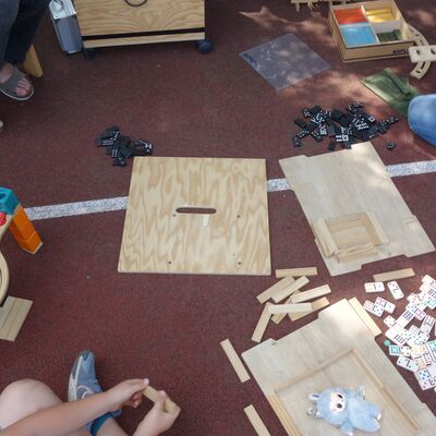 Bild vergr&ouml;&szlig;ern: Kinder experimentieren mit Domino-Steinen und Murmelbahnen